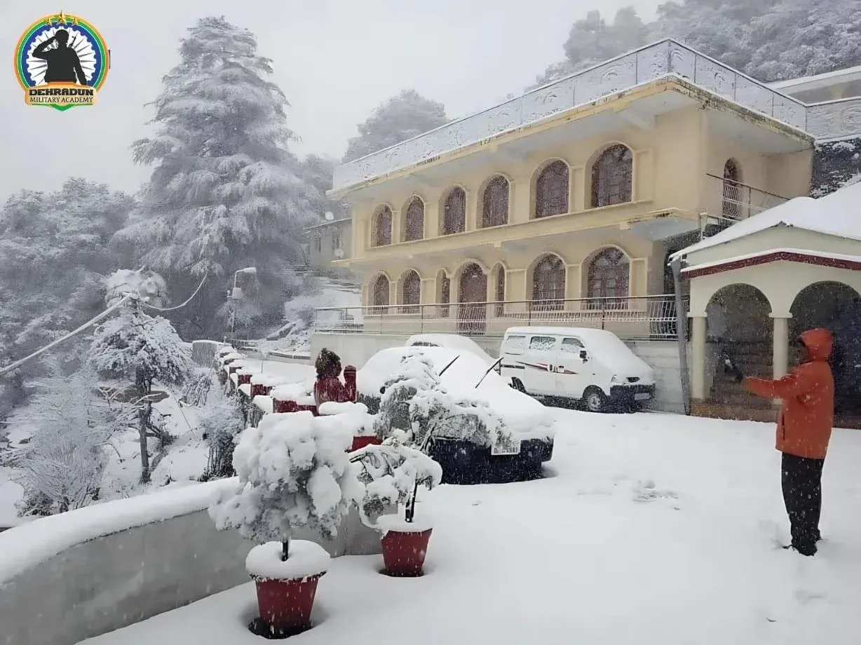 Dehradun Military Academy campus in Mussoorie covered in snow with cadets enjoying winter weather.